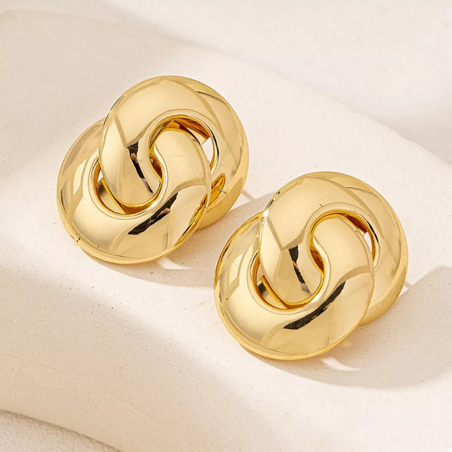 Chunky knot gold-plated earrings with interlocking links.
