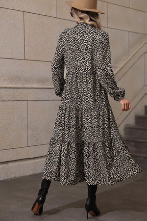 Chic midi dress with balloon sleeves, black animal print, tiered skirt, and collared neckline.