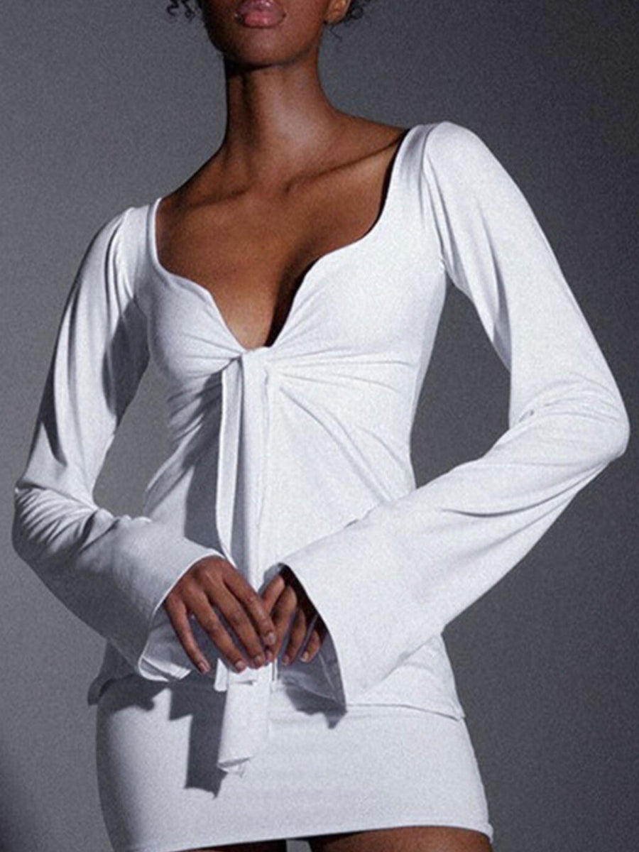 White tie-front long sleeve blouse with a deep V-neckline and flared cuffs.