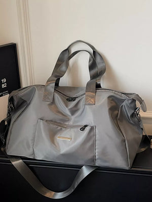 Gray Oxford cloth travel bag with multiple zippered pockets and shoulder strap.