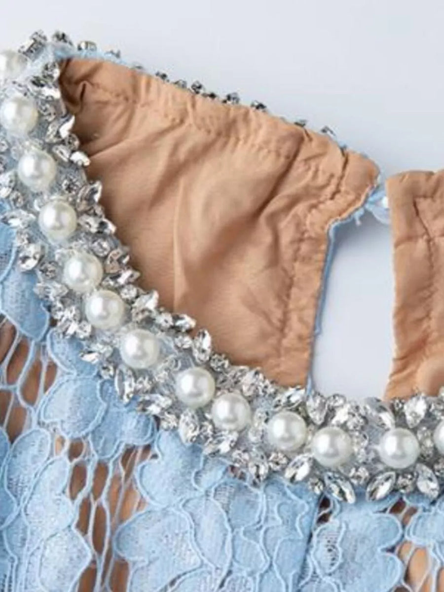 Blue lace dress with pearl and crystal embellished neckline detail