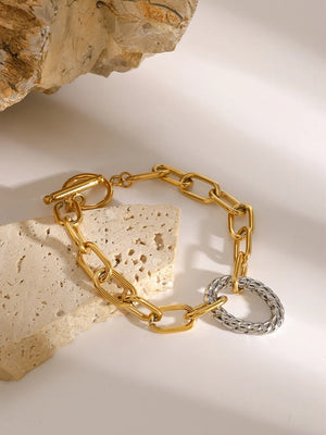 Gold two-tone link toggle bracelet with a textured ring detail