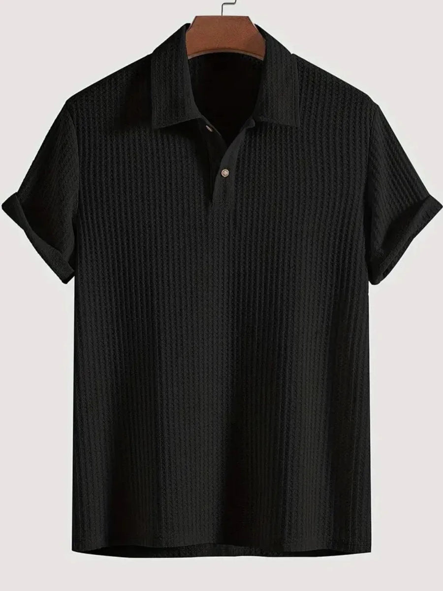Black textured polo shirt with rolled sleeve detail and button placket.