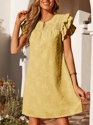 Apricot floral embossed mini dress with smocked bodice and ruffled sleeves.