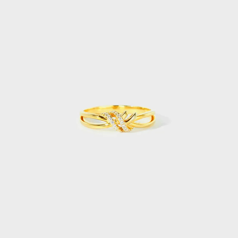 Gold ring with diamond-kissed knot detail, 18K gold-plated.