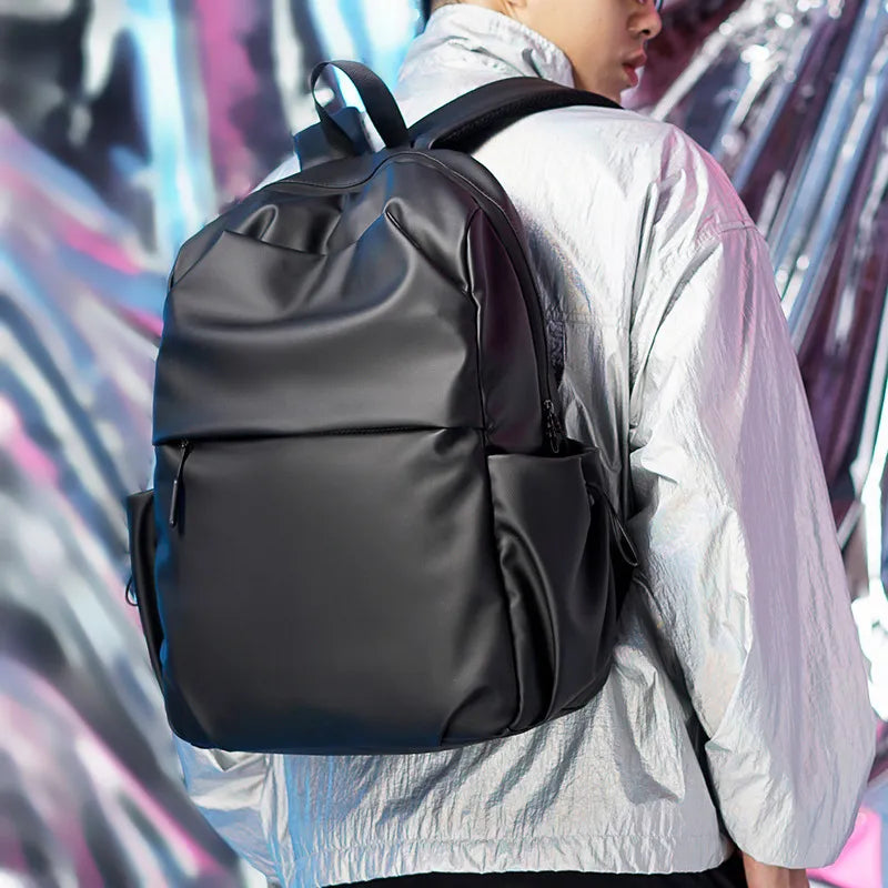 Black tech backpack with multiple pockets and zippers, made of canvas material.