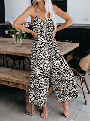 Leopard print wide leg jumpsuit with spaghetti straps and a tie-front neckline.