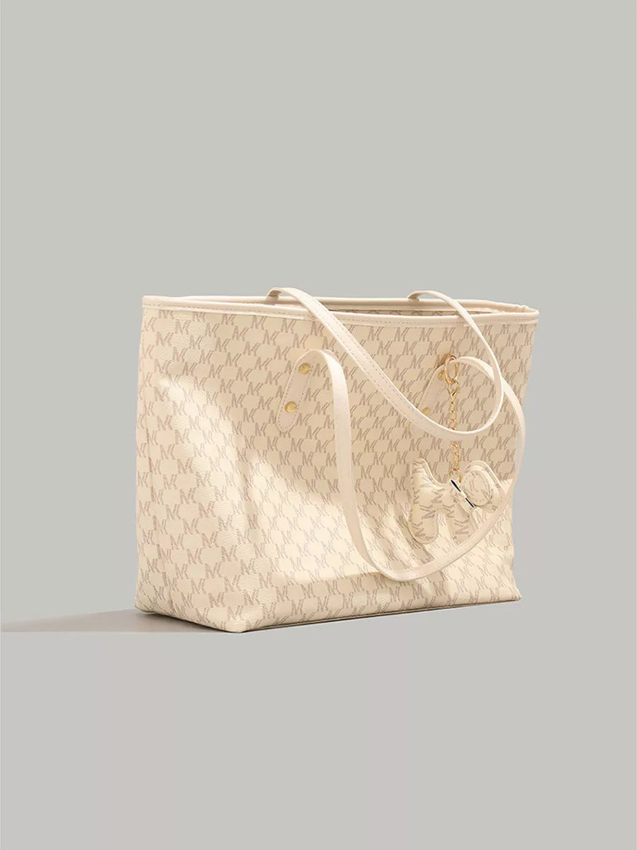 Ivory monogram tote bag with dog charm and cream straps