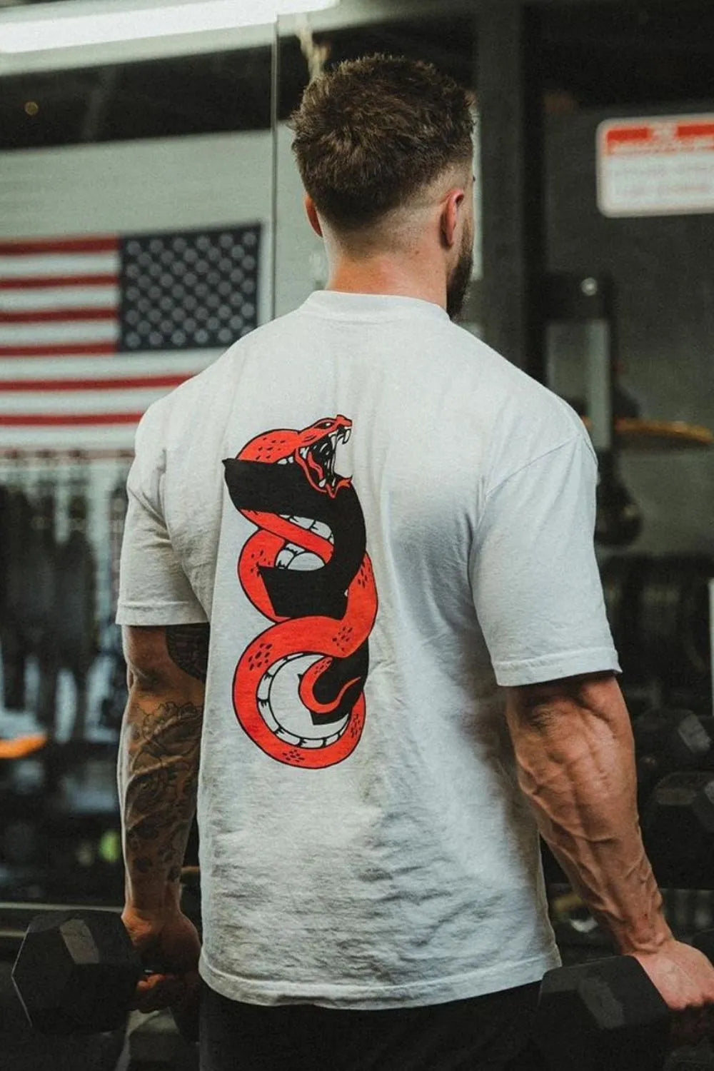 Oversized white graphic tee with a red coiled snake design on the back.