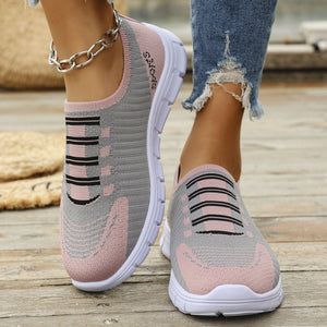 Mesh slip-on sneakers in pink and gray with black stripe detail and white soles.