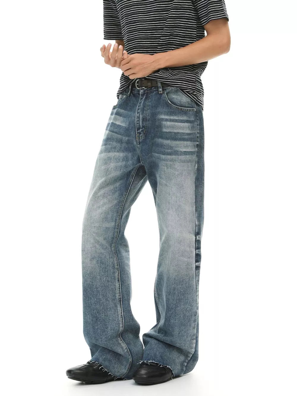 Men's blue wash cotton flare jeans with a faded look and distressed hem.