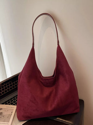 Women's casual suede shoulder bag in rust with a single strap.