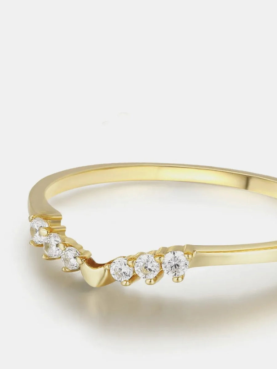 Gold chevron diamond band ring with seven small round stones.