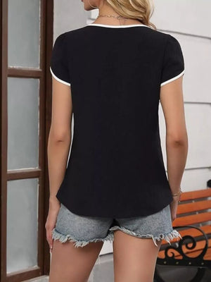 Black blouse with white trim, petal sleeves, and V-neck.