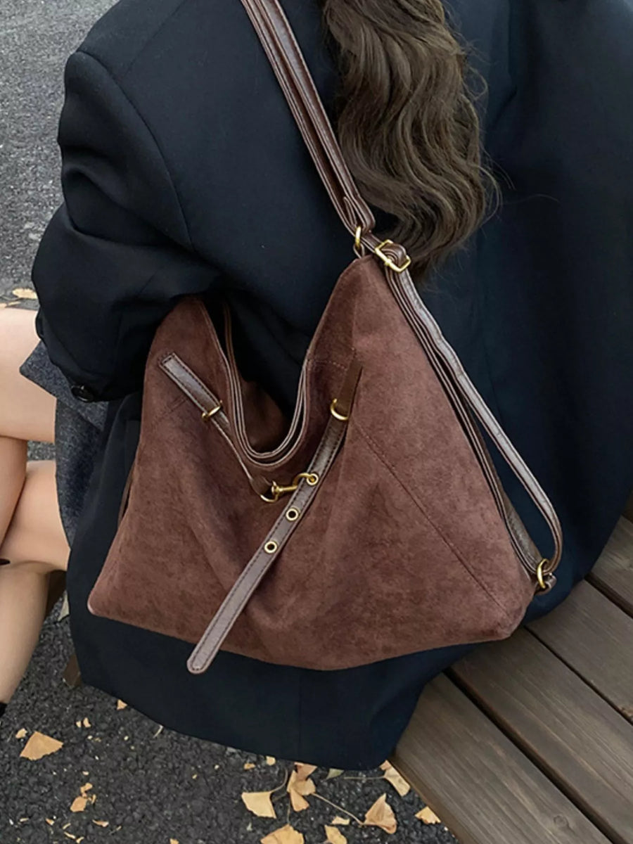Brown suede tote bag with adjustable straps and gold hardware detail