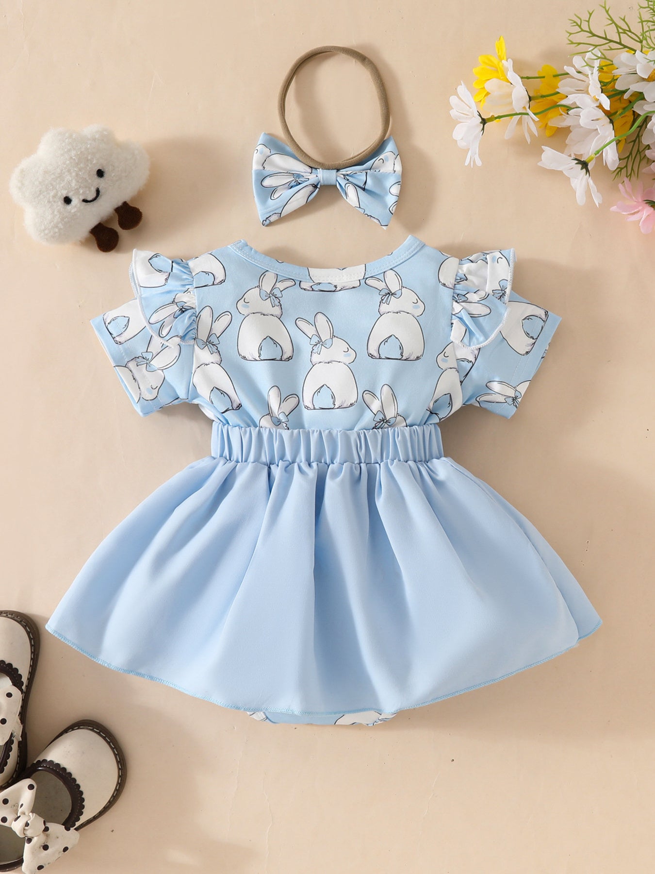 Sky blue baby dress set with bunny print, ruffle sleeves, and matching bow headband.