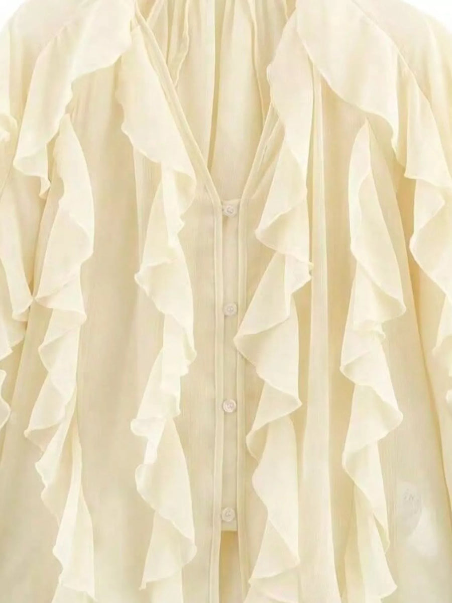 Beige sheer long-sleeve blouse with cascading ruffles and button front.