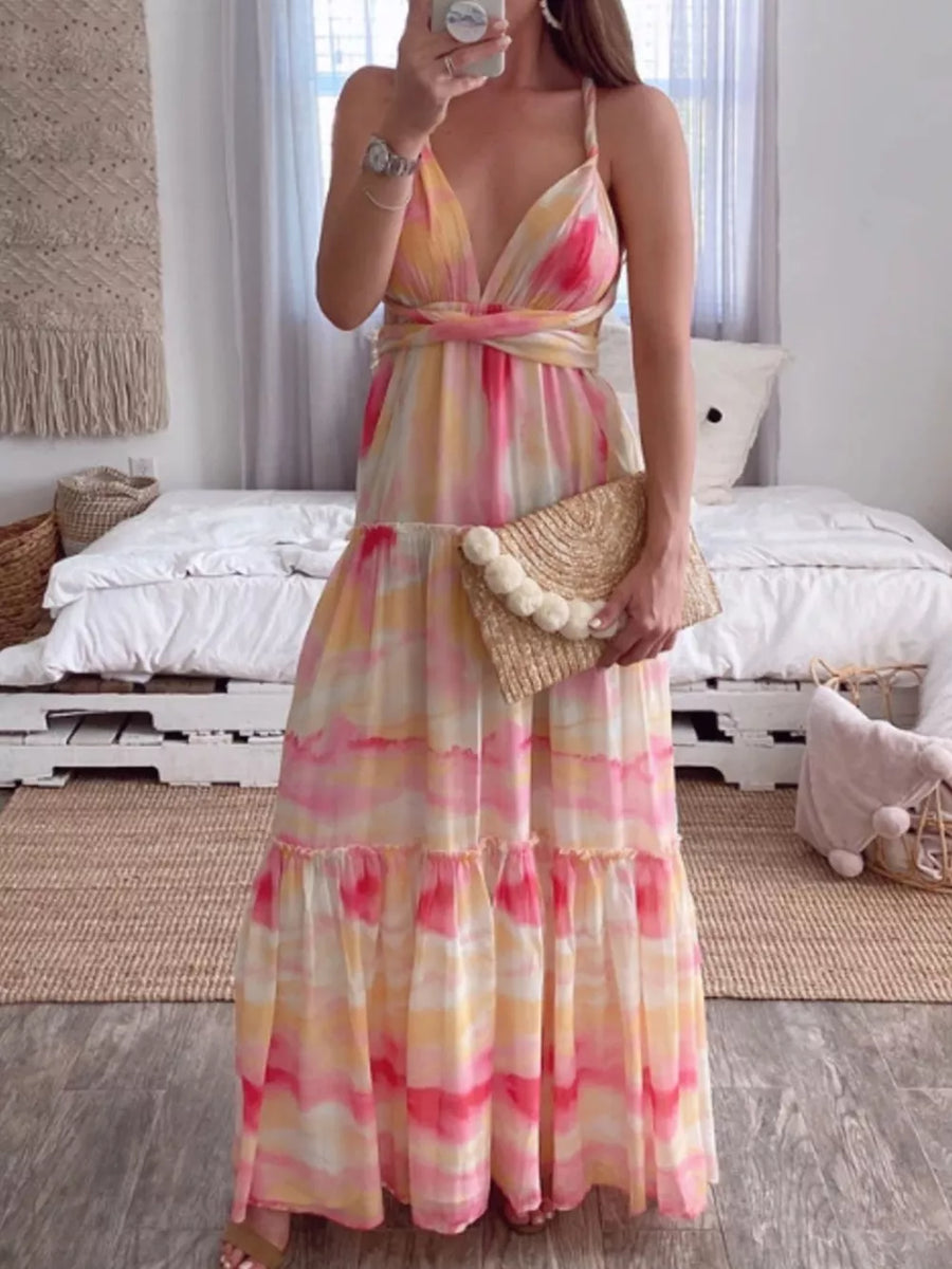 Vibrant tie-dye maxi dress with halter neckline, pink yellow and white watercolor print, tiered skirt