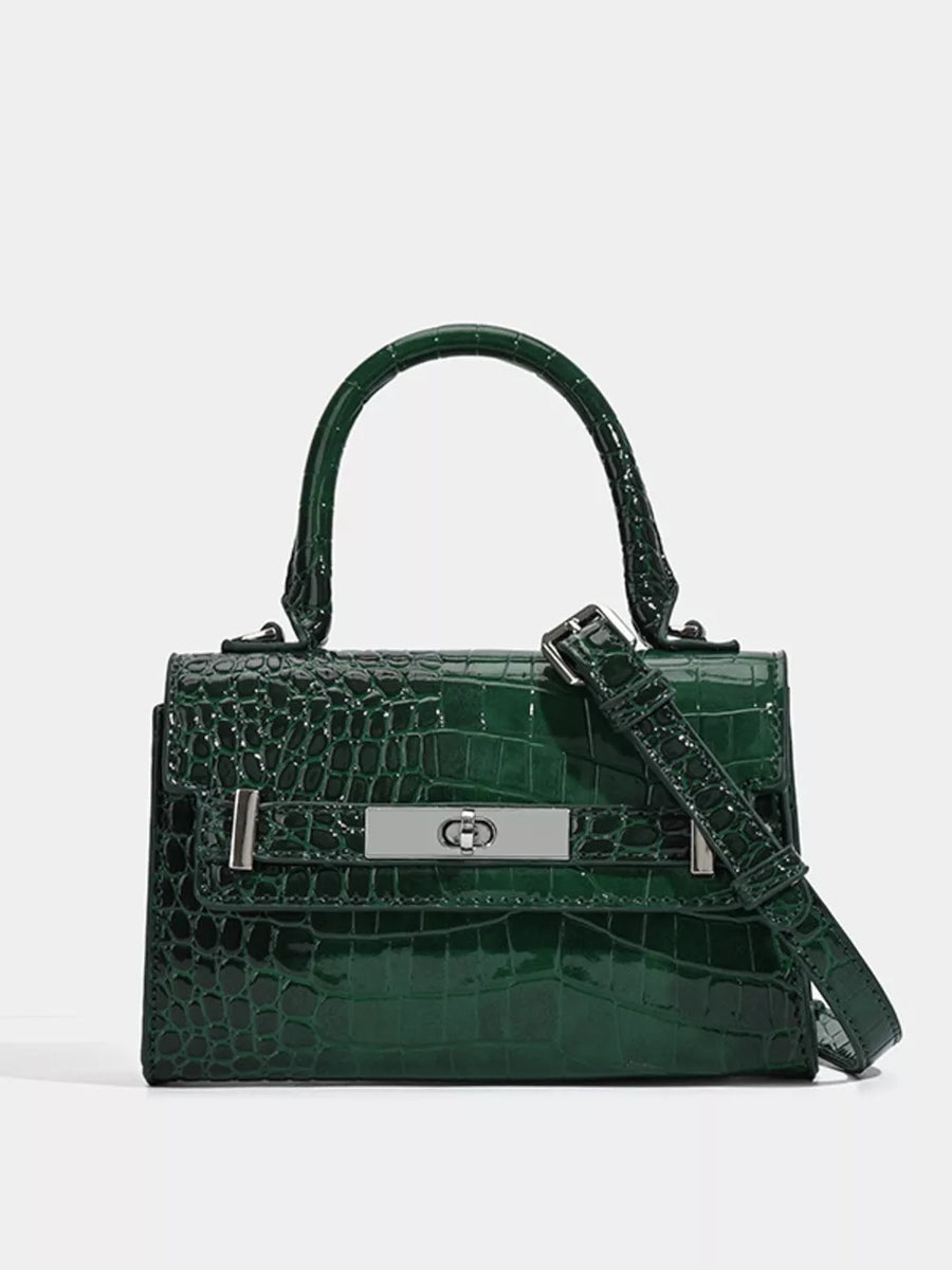 Green croc-embossed small tote bag with silver hardware and adjustable strap.