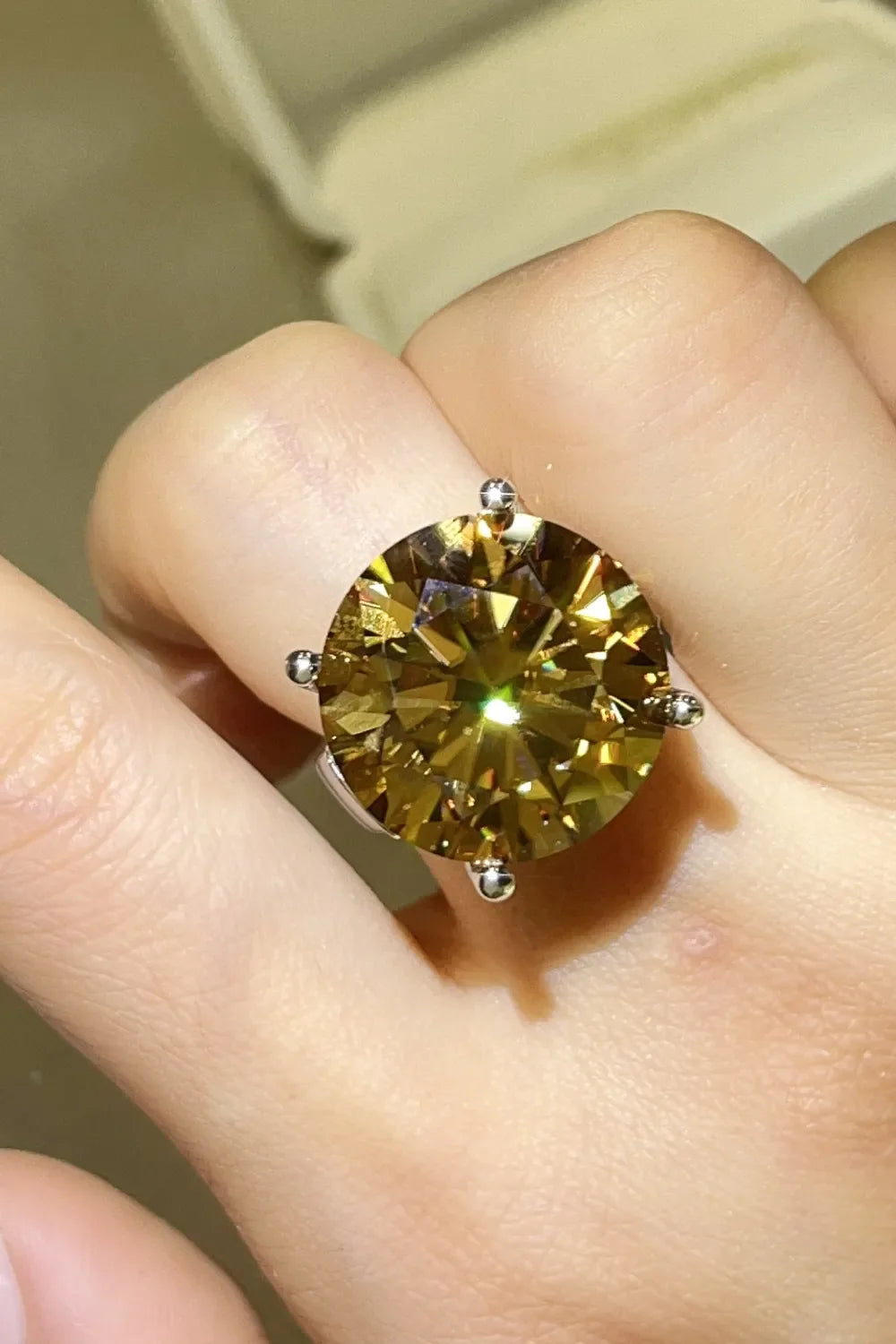 Gold radiant cut moissanite cocktail ring with large, bright yellow stone.