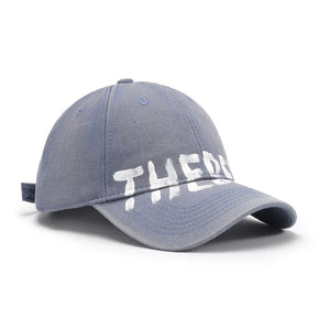 Dusty Blue textured denim baseball cap with white graphic text.