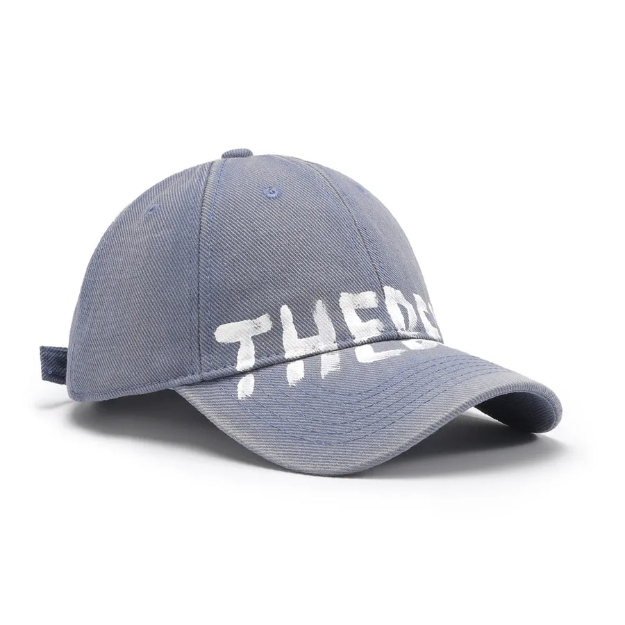 Dusty Blue textured denim baseball cap with white graphic text.