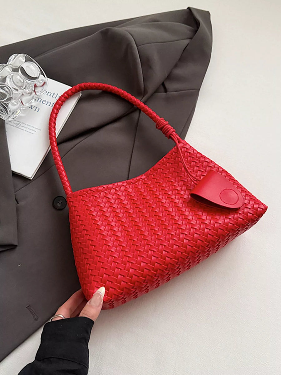 Red woven shoulder bag with braided strap and leather detail