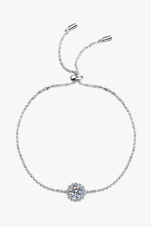 Silver 925 sterling silver adjustable bracelet with a round-cut cubic zirconia flower charm.