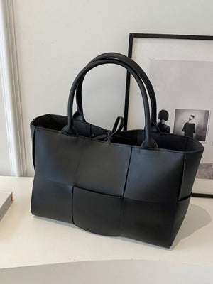 Black woven pu leather large tote bag with dual handles and tie closure.