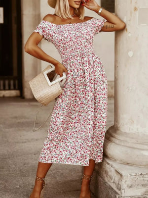 Off-shoulder midi dress with a white floral print and smocked bodice.