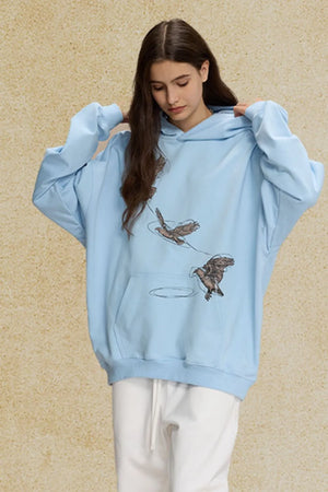 Light blue relaxed fit hoodie with embroidered birds and a front pocket.