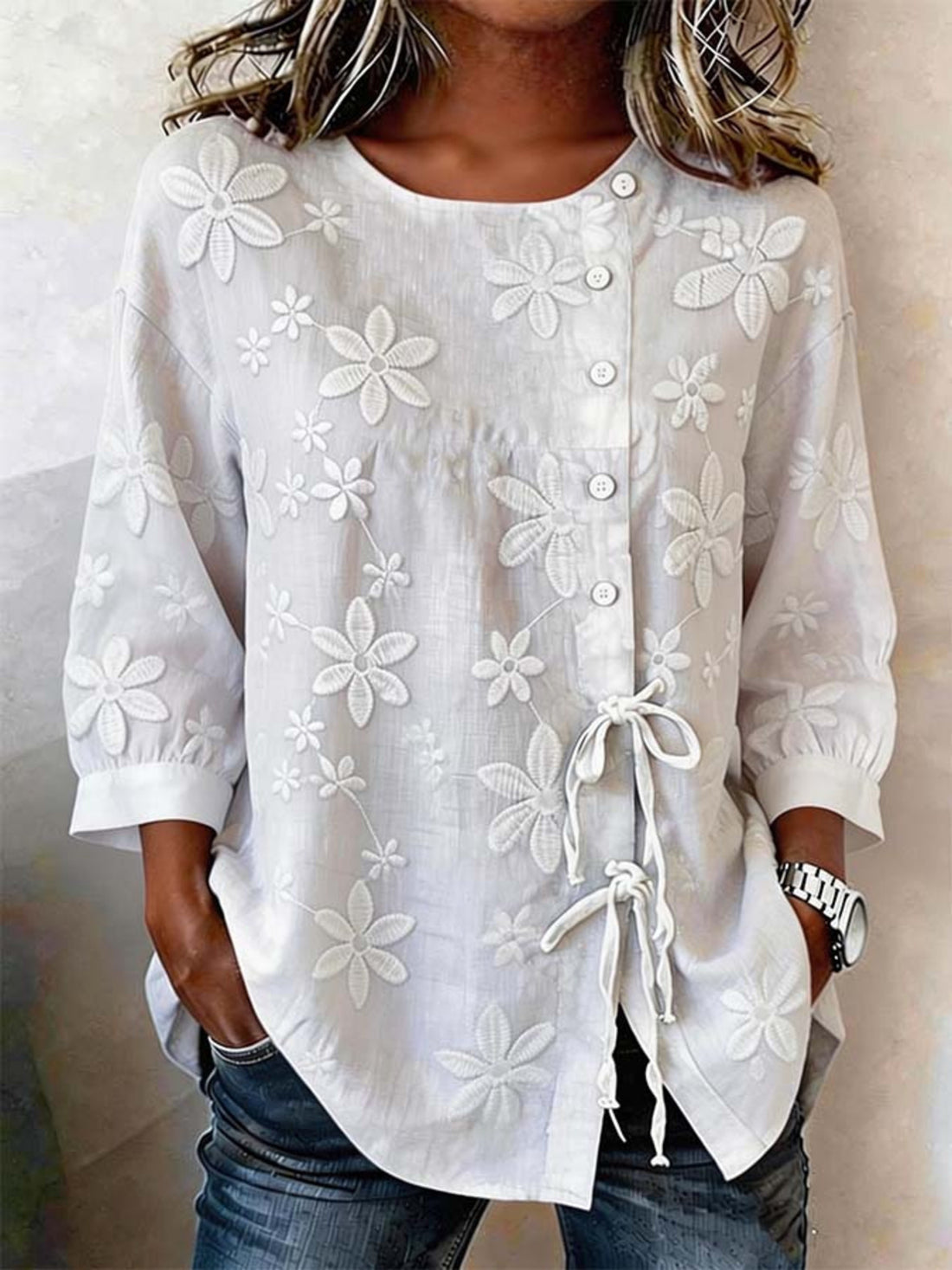White embroidered floral button-down shirt with 3/4 sleeves and tie detail