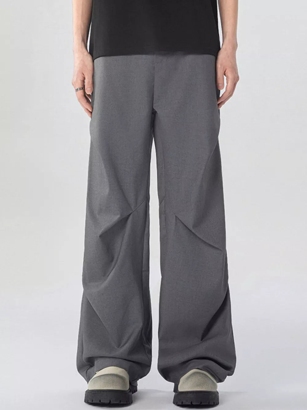 Oversized wide-leg cargo sweatpants in dark gray with unique paneling detail.