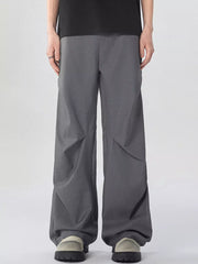 Oversized wide-leg cargo sweatpants in dark gray with unique paneling detail.