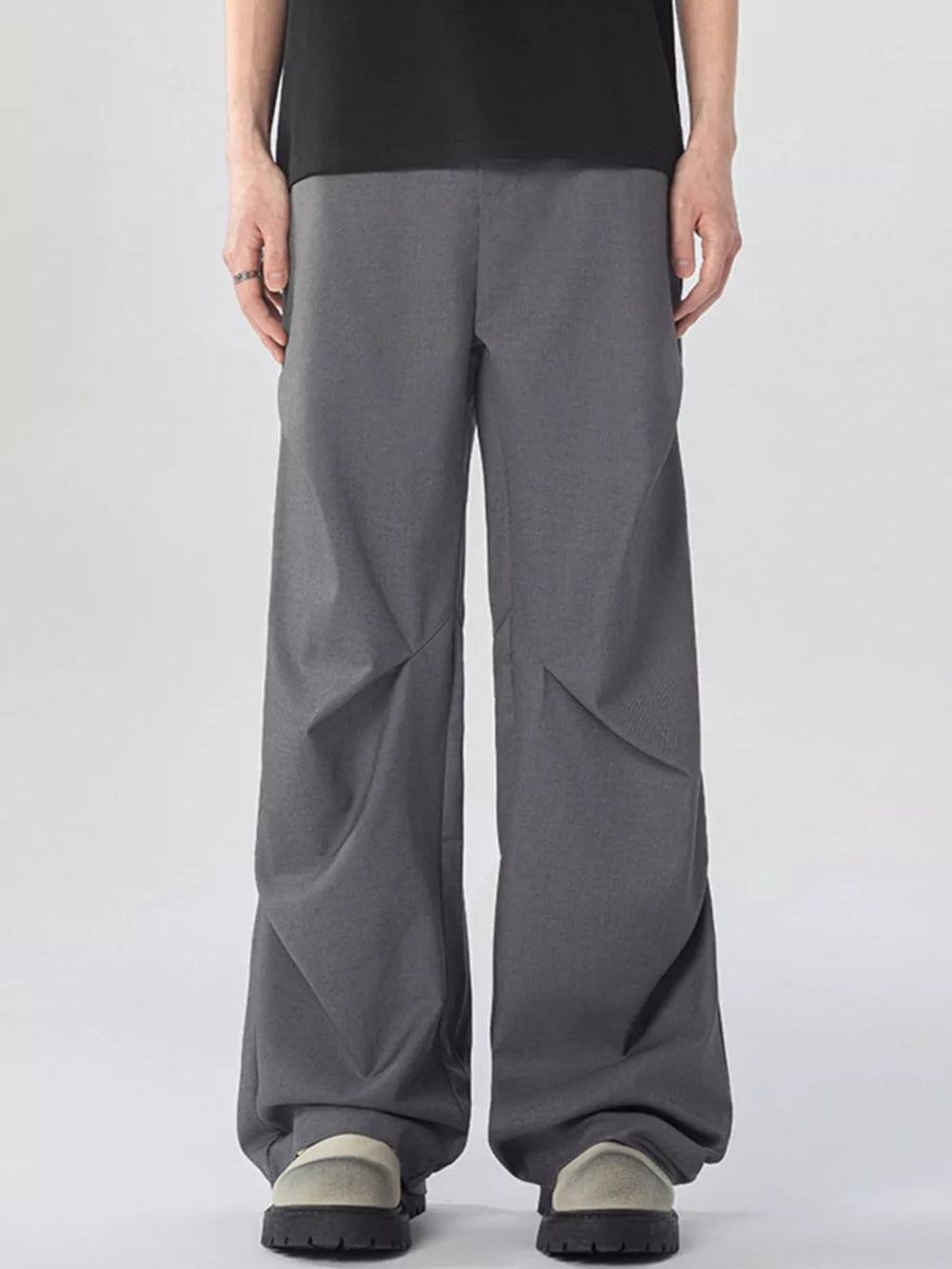 Oversized wide-leg cargo sweatpants in dark gray with unique paneling detail.