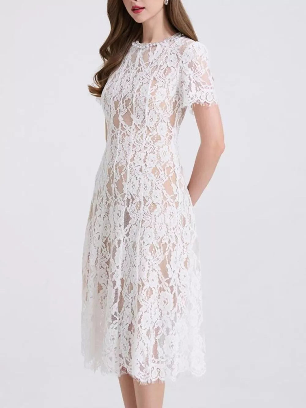 White lace midi dress with short sleeves and pearl embellishments at the neckline.