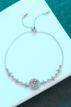 Silver moissanite bracelet with a central halo design and star accents.