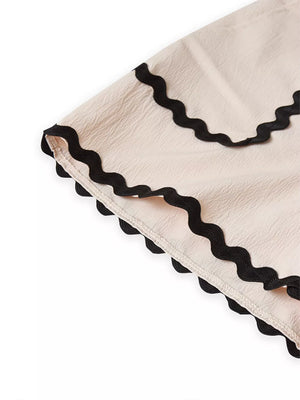 Scalloped trim tank and shorts set in cream with black wavy trim detail.
