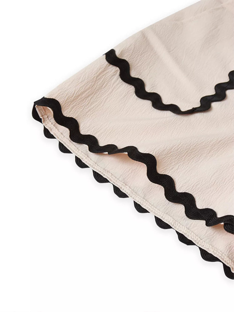 Scalloped trim tank and shorts set in cream with black wavy trim detail.