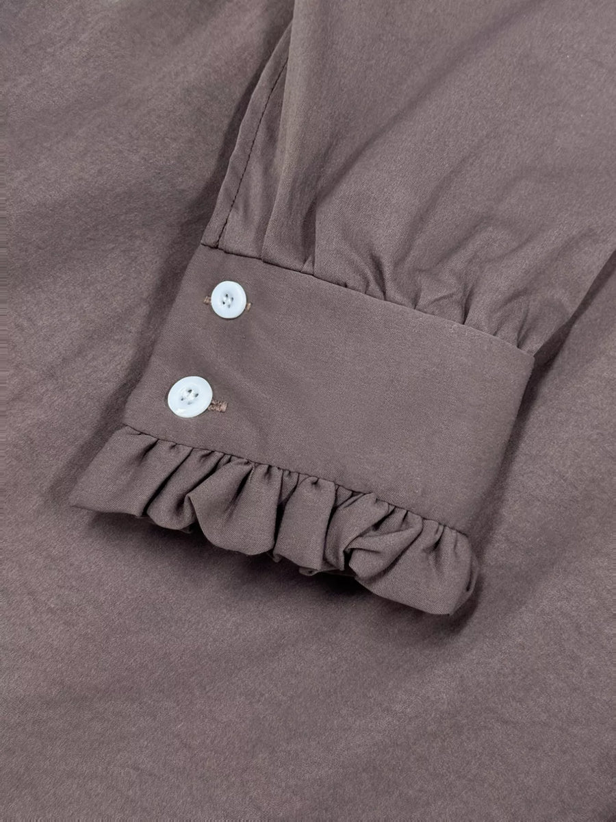 Coffee brown midi dress sleeve cuff with ruffle hem and two white buttons.