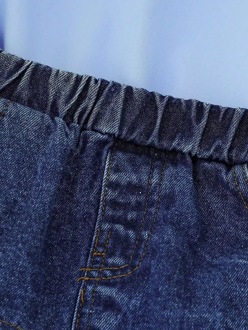Denim skirt with elastic waistband and contrast stitching detail.