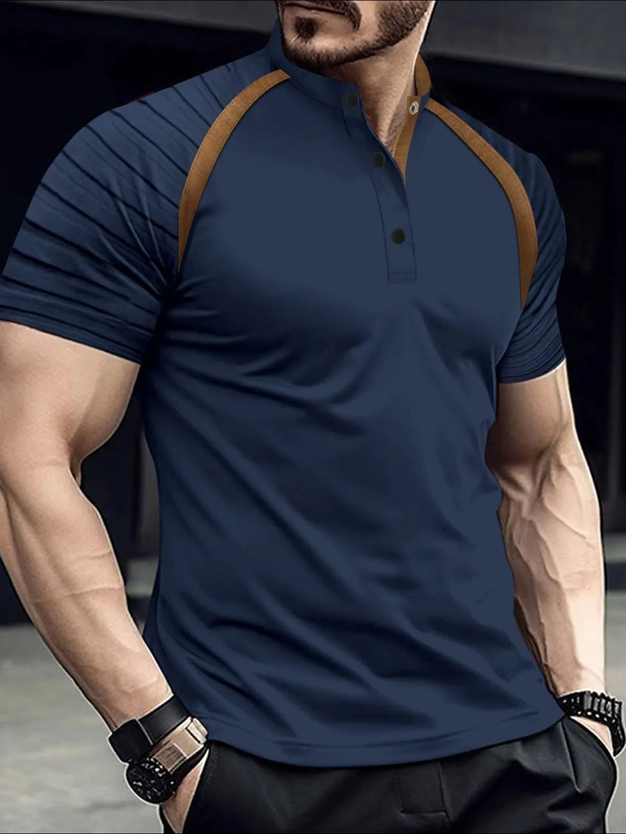 Navy polo shirt with mandarin collar, contrast tan raglan sleeves and striped detail.