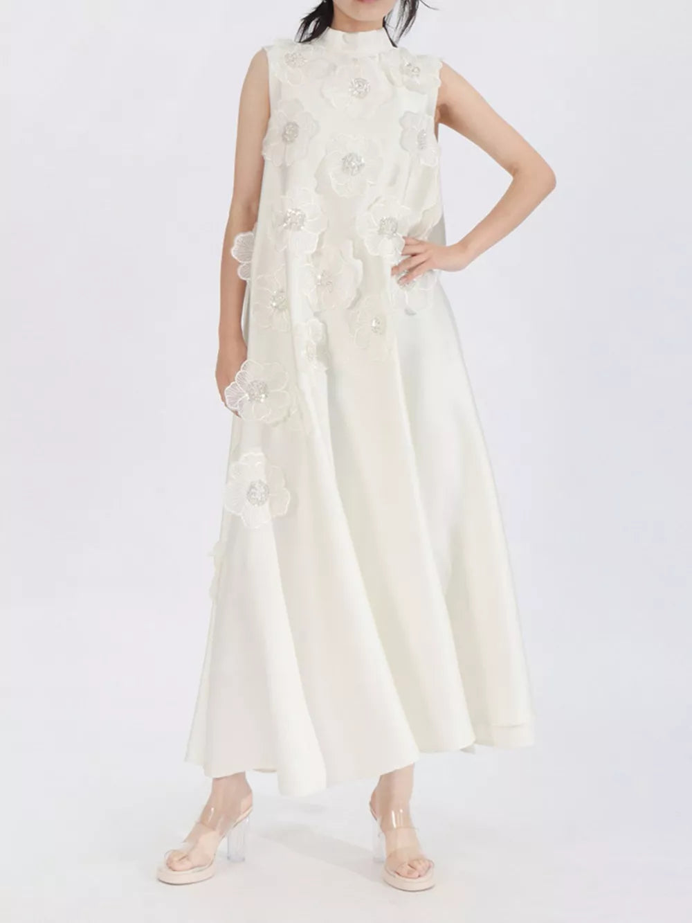 White sleeveless midi dress with floral appliques and mock neck.