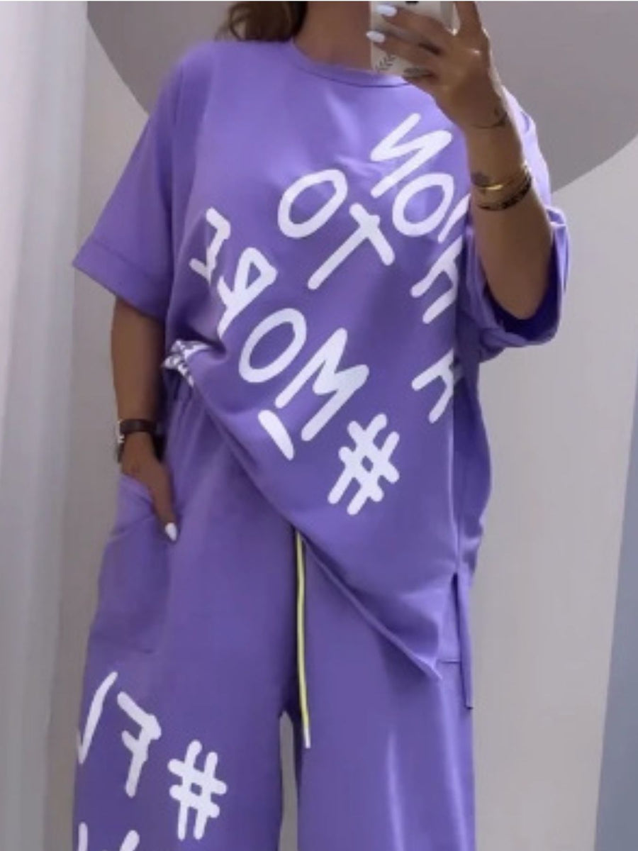 Purple graphic tee and drawstring pants set with white text and hashtag print.