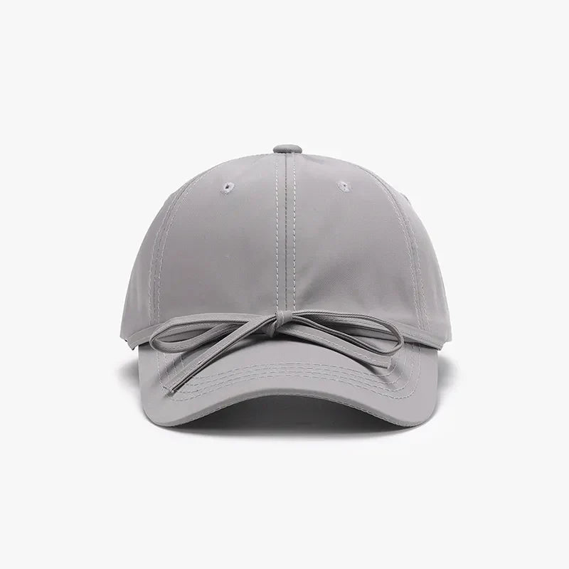 Gray baseball cap with a tied back bow detail