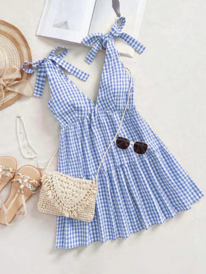 Blue gingham maternity mini dress with tie shoulders and ruffle hem
