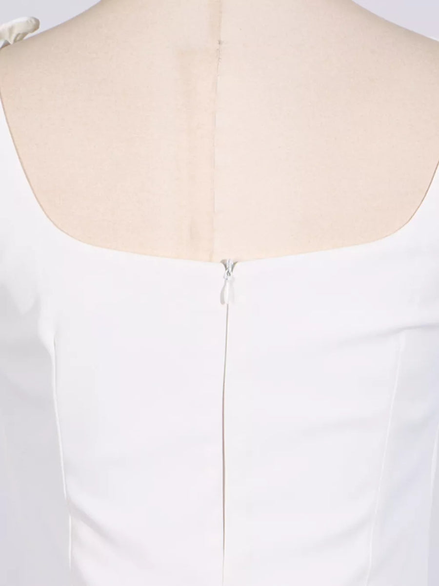White square neck mini dress with zipper back and bow detail on shoulder.