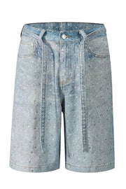 Embellished denim bermuda shorts in medium wash with allover rhinestones and a tie waist.