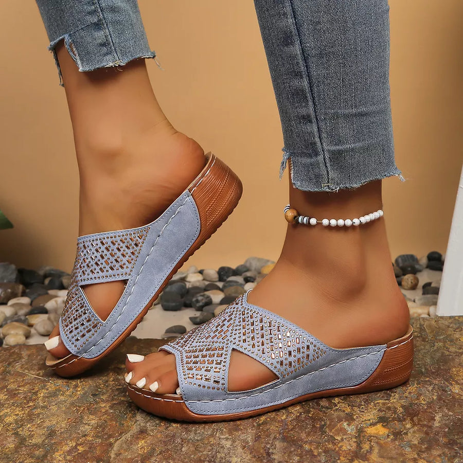 Sky blue rhinestone-embellished open toe wedge sandals with criss-cross straps.