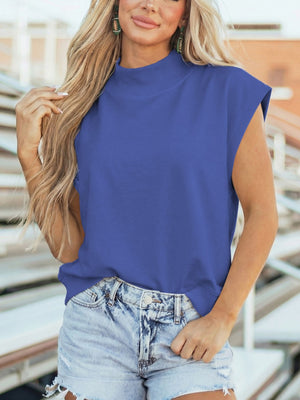 Ribbed mock neck cap sleeve shirt in Dusty Blue, styled with denim shorts.